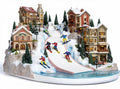 Ski resort decorative village scene with skiers and illuminated buildings